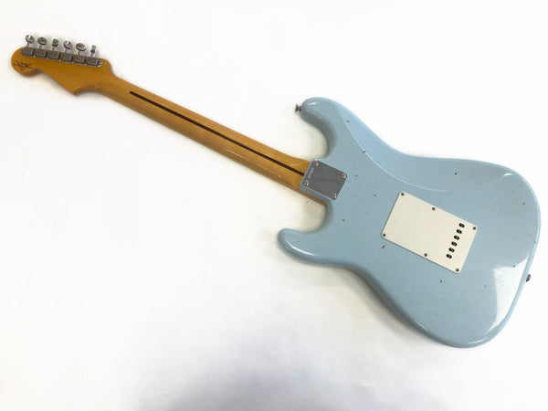 Back side of light blue electric guitar with maple neck and six tuning pegs on headstock on white background