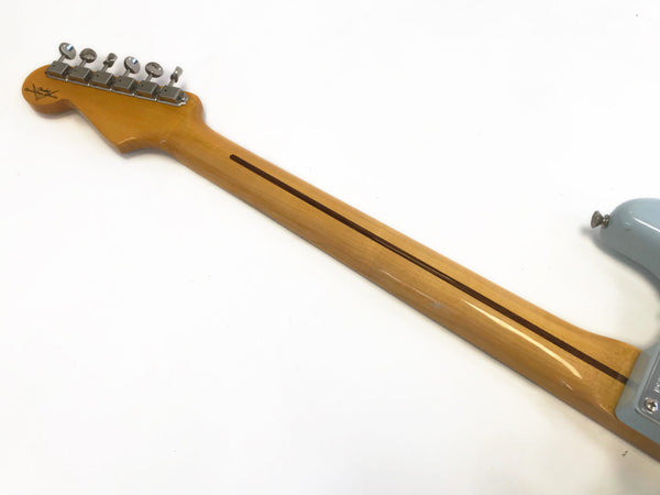 Maple neck with skunk stripe on electric guitar, vintage style tuning pegs and light wood finish detail against white background