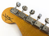 Close-up of Fender Custom Shop electric guitar headstock with vintage-style tuning pegs on a natural wood finish