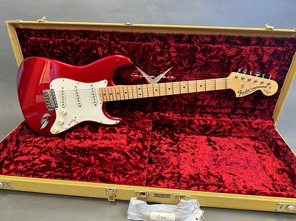 Red Fender Stratocaster electric guitar with maple neck and white pickguard in open tweed hard case with red plush interior at Coffee House Guitars