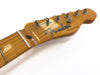 Close-up of Fender Telecaster electric guitar headstock with tuning pegs and strings on white background