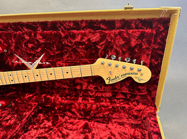 Fender Stratocaster guitar headstock with maple fretboard inside red plush lined guitar case