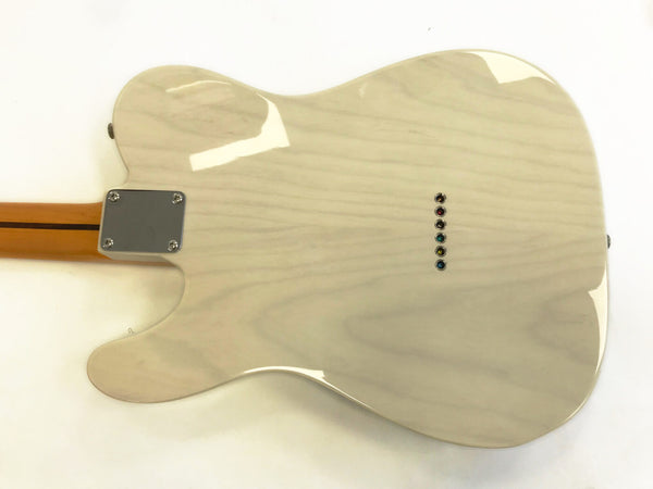 Back view of a light-colored electric guitar with a natural wood grain finish and six string ferrules, featuring a bolt-on neck with a metal neck plate and maple fretboard.