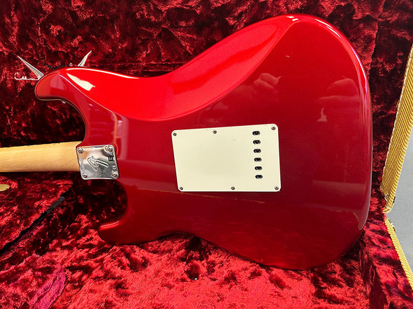 Red Fender electric guitar body back with white tremolo cavity cover in red plush-lined guitar case