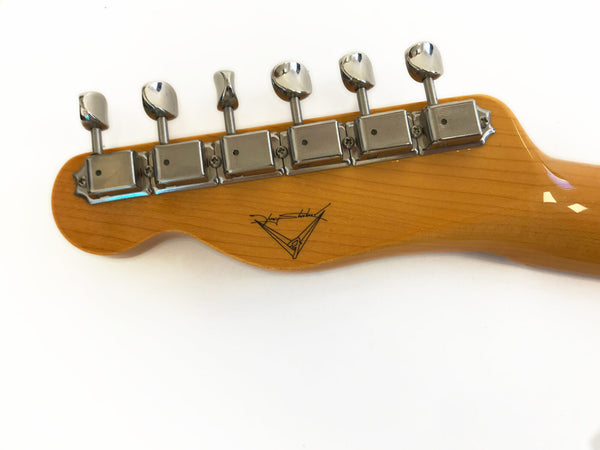 Close-up of guitar headstock with six chrome tuning pegs and signature logo on natural wood finish neck against white background