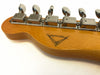 Close-up of maple guitar headstock with vintage-style tuning machines and unique signature logo on back of neck.