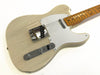 Cream colored electric guitar with white pickguard and maple fretboard on white background