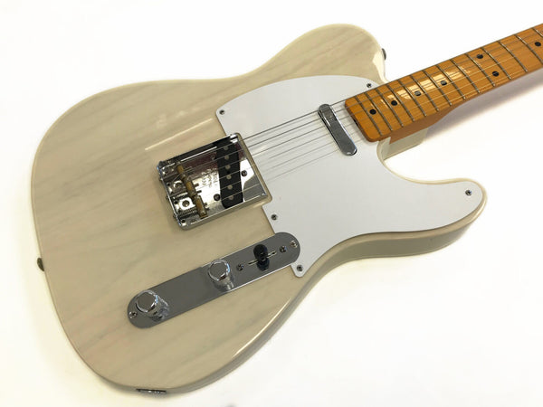 Cream colored electric guitar with white pickguard and maple fretboard on white background
