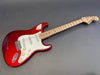 Fender Standard Stratocaster electric guitar in red with maple neck and white pickguard on gray background