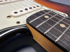 Close-up of guitar neck and pickups showing frets, strings, and pickguard on electric guitar from Coffee House Guitars product listing