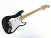 Black Fender Stratocaster electric guitar with maple neck and white pickguard on white background