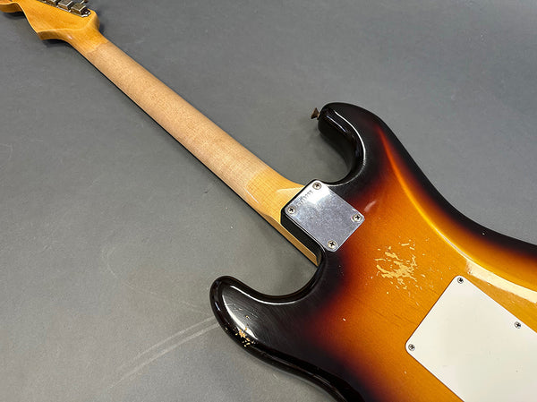 Vintage sunburst electric guitar body close-up showing neck joint and wear marks on dark gray background