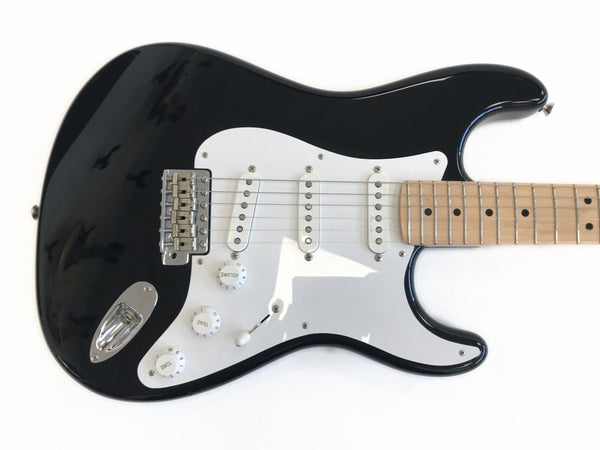 Black electric guitar with white pickguard and maple fretboard, three single-coil pickups, volume and tone control knobs, and chrome hardware on white background