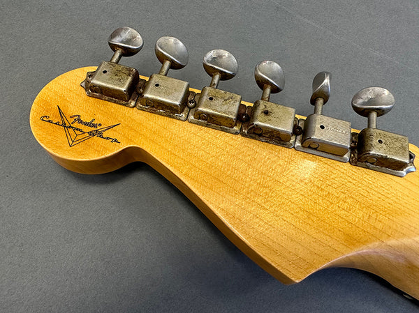 Vintage Fender Custom Shop tuning pegs on maple guitar headstock with Fender Custom Shop logo on gray background