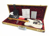 Fender Custom Shop electric guitar with maple neck and vintage white finish, displayed in tweed hard case with red plush interior, including Fender Custom Shop documentation, certificate of authenticity, and accessories.
