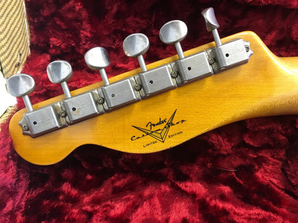 Fender Custom Shop Limited Edition guitar headstock with vintage tuning pegs on red plush guitar case interior