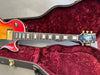 Gibson Les Paul electric guitar with sunburst finish inside red velvet-lined hardshell case