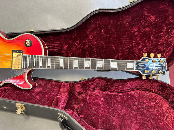 Gibson Les Paul electric guitar with sunburst finish inside red velvet-lined hardshell case