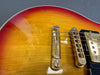 Close-up of sunburst electric guitar body showing gold bridge, tailpiece, and strings on Coffee House Guitars product listing