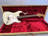 Vintage white Fender Stratocaster electric guitar with rosewood fretboard in open tweed guitar case with red plush interior from Coffee House Guitars