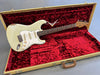 Vintage Fender Stratocaster electric guitar with white finish and rosewood fretboard in tweed hard case with red velvet interior