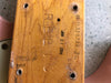 Close-up of guitar neck heel showing the serial number #11330738-36, handwritten markings, and stamped letters "RELC" on natural wood finish