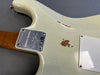Close-up of the back body of a Fender Limited Edition electric guitar showing worn vintage white finish and neck plate with serial number and Fender logo.