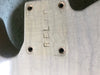Close-up of vintage cream guitar body with "REFL" embossed near neck plate screw holes and visible aging cracks in the finish