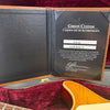 Gibson Custom Certificate of Authenticity inside guitar case with part of honey burst electric guitar body visible