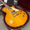 Gibson Les Paul electric guitar with honey burst finish and flame maple top in a red velvet-lined hard case
