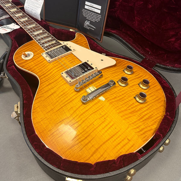 Gibson Les Paul electric guitar with honey burst finish and flame maple top in a red velvet-lined hard case