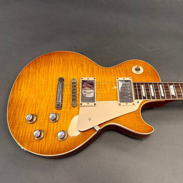 Electric guitar with sunburst finish, dual humbucker pickups, chrome hardware, and cream pickguard on gray background