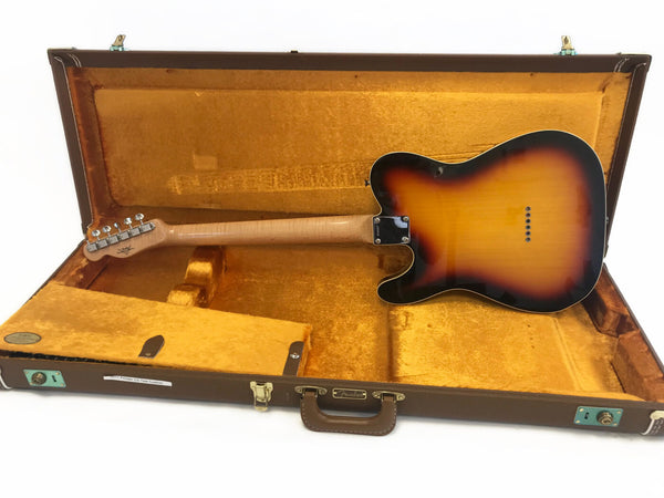 Back view of sunburst Fender Telecaster electric guitar inside vintage brown and gold plush lined Fender hard case.