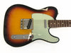 Sunburst electric guitar body with white pickguard and chrome hardware on white background