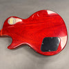 Back view of red Gibson Les Paul electric guitar showing wood grain and control cavity cover