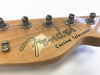Close-up of Fender Custom Telecaster guitar headstock with tuning pegs and strings on natural wood finish