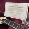 Gretsch certified guarantee certificate with guitar neck and strap buttons in plush red guitar case