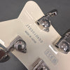 Close-up of white guitar headstock with chrome Grover tuning pegs and serial number JT23010453 Made in Japan stamp