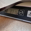 Close-up of a guitar weight measurement on a digital scale showing 3.716 kilograms at Coffee House Guitars.