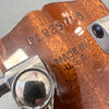 Close-up of guitar headstock with Grover tuning peg and serial number 0125716, made in U.S.A. stamped on wood.
