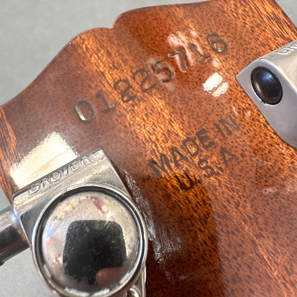 Close-up of guitar headstock with Grover tuning peg and serial number 0125716, made in U.S.A. stamped on wood.