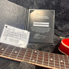 Gibson Custom Certificate of Authenticity with serial number and guitar neck fretboard in guitar case with plush lining and authenticity card.