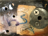 Close-up detail of vintage guitar neck plate area showing serial number markings, screws, and wood grain with visible wear and paint chipping.