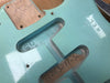 Close-up of vintage light blue electric guitar body showing pickup cavities, serial number 11263277-34, and handwritten neck pocket markings.
