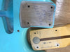 Close-up of neck pocket and neck heel of a vintage electric guitar showing handwritten serial numbers and dates on light blue guitar body and maple neck with walnut stripe.