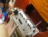 Close-up image of vintage guitar humbucker pickup labeled "Patent Applied For" being installed in a sunburst electric guitar body with braided wiring visible.