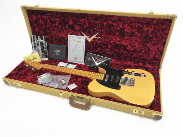 Fender Telecaster electric guitar in blonde finish with black pickguard displayed in open tweed hard case with red plush interior, including Fender Custom Shop certificate of authenticity and accessories