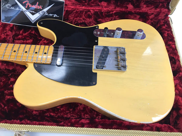 Vintage blonde Fender Telecaster electric guitar with black pickguard and chrome hardware in red velvet-lined case