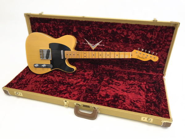 Fender Telecaster electric guitar with maple neck and black pickguard in open vintage tweed hard case with red plush interior lining.