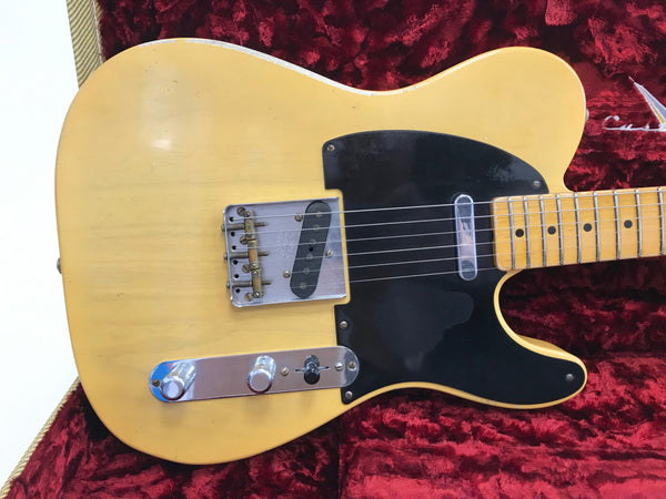 Vintage blonde electric guitar with black pickguard and chrome hardware in red plush case